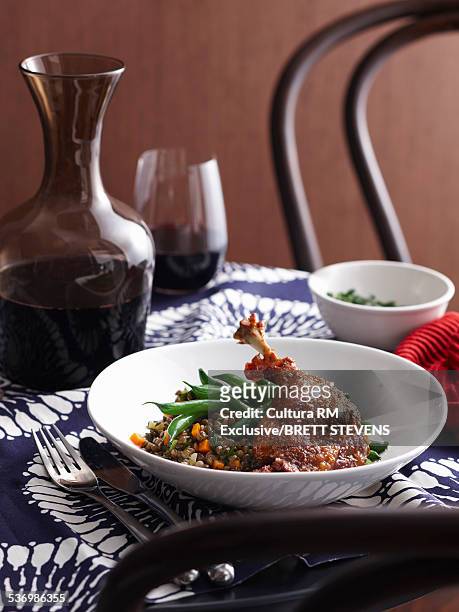 bowl of confit duck with lentils and green beans - confit stock pictures, royalty-free photos & images