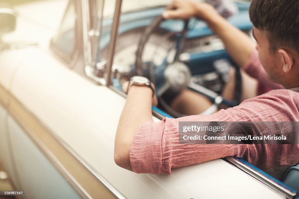 Young man driving convertible