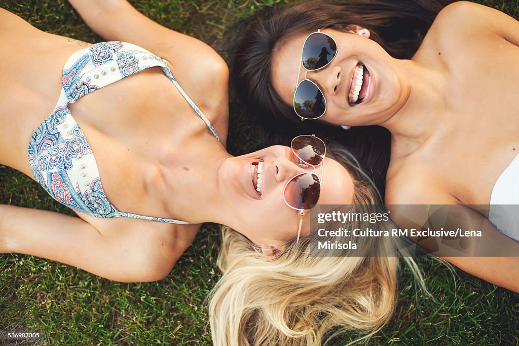 Young women on grass at pool party