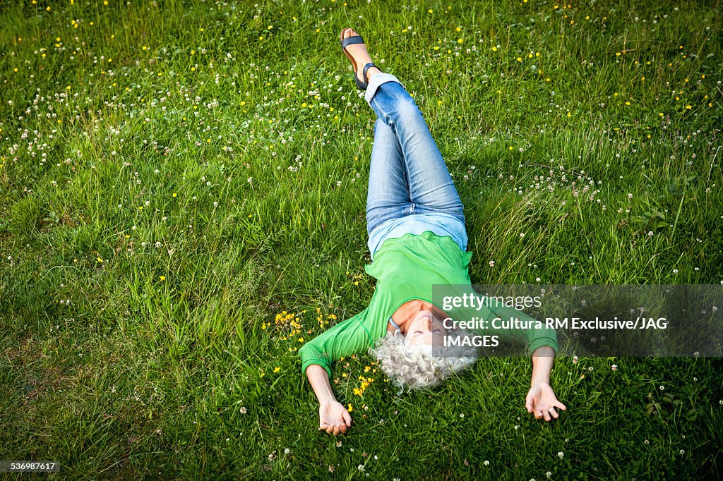 Overhead view of woman lying on grass
