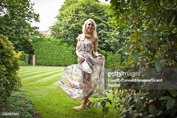 young woman dancing in garden - woman in maxi dress stock pictures, royalty-free photos & images