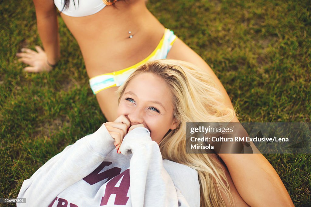 Young women on grass at pool party