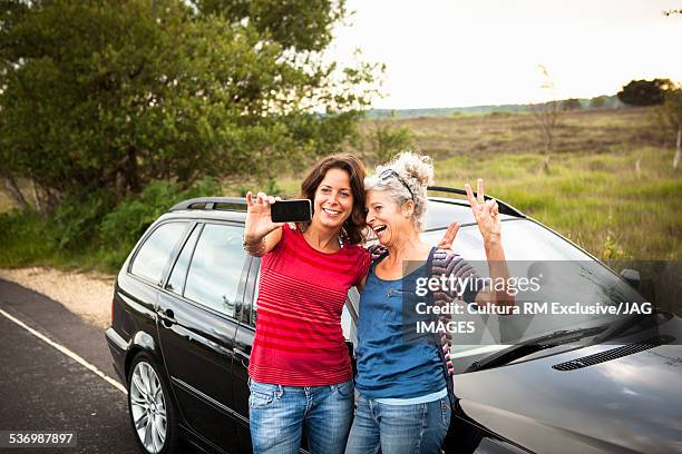 mother and daughter taking selfie by car, studland, dorset - car close up stock pictures, royalty-free photos & images