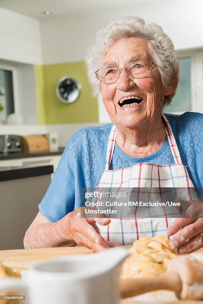 Grandmother kneading dough