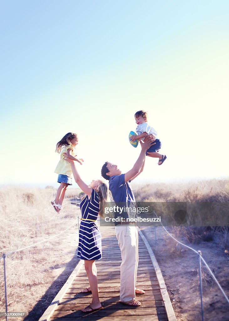 Parents holding kids in air