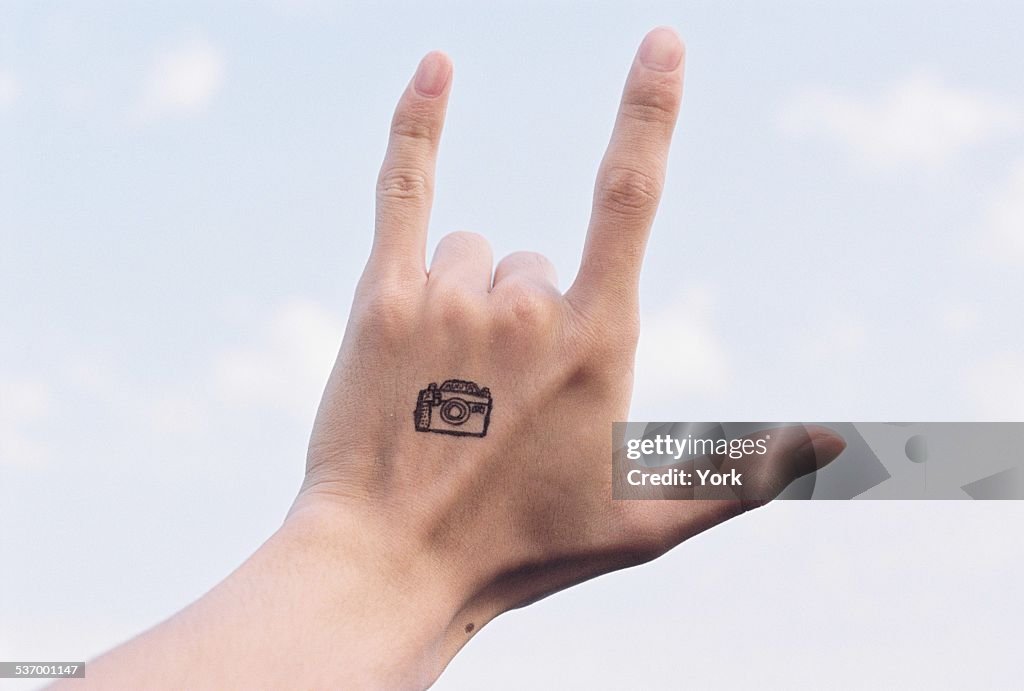 Hand With Camera Tattoo Making I Love You Sign High-Res Stock Photo - Getty  Images