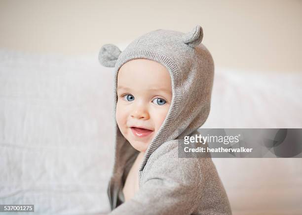 portrait of boy wearing a hooded top - baby cute stock-fotos und bilder