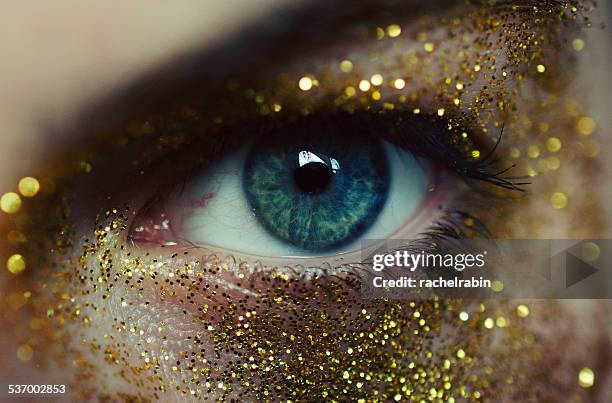 Close-up of woman eye with gold glitters