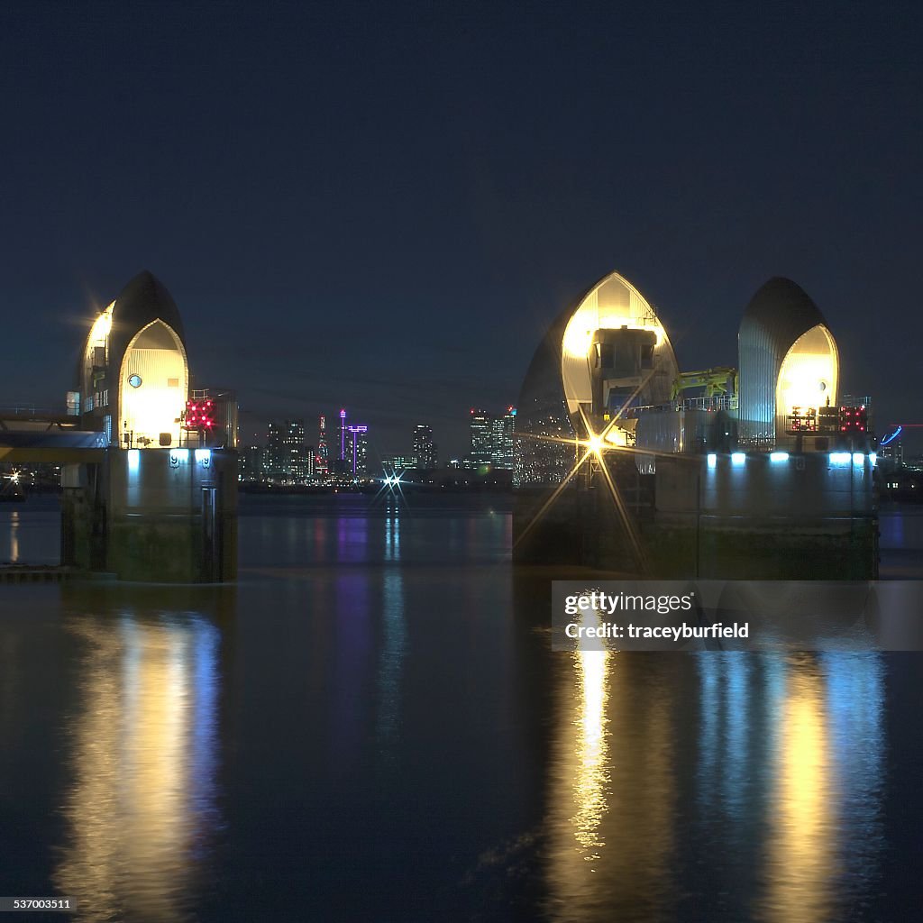 United Kingdom, England, London, Canary Warf, River Thames, Illuminated piers of Thames Barrier at calm night
