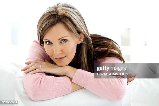 gorgeous woman relaxing on bed - brunette woman bed stock pictures, royalty-free photos & images