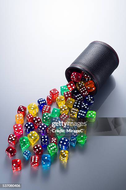 colorful dices spilling from dice cup - ludo stock pictures, royalty-free photos & images