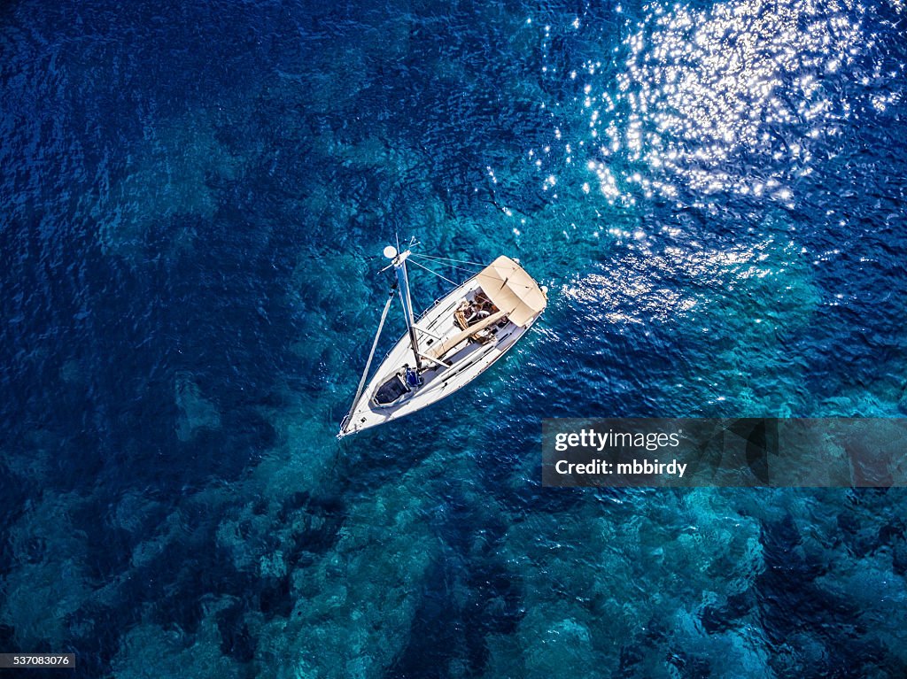 Anchored sailboat, view from drone