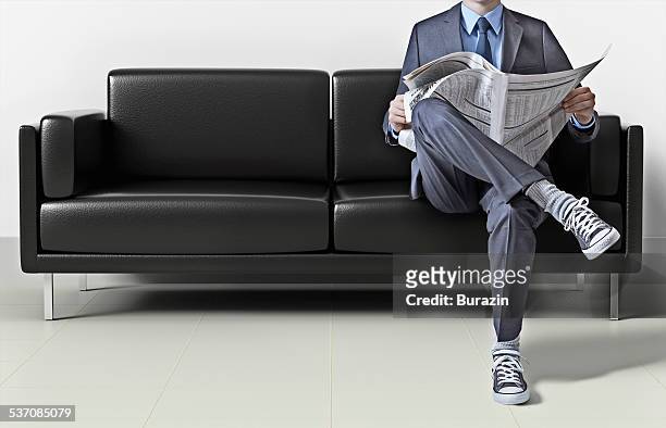 business man in suit wearing sneakers - legs crossed at knee stock pictures, royalty-free photos & images