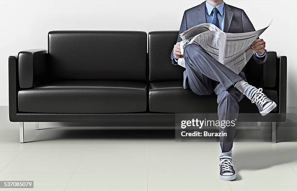 business man in suit wearing sneakers - legs crossed at knee stock pictures, royalty-free photos & images