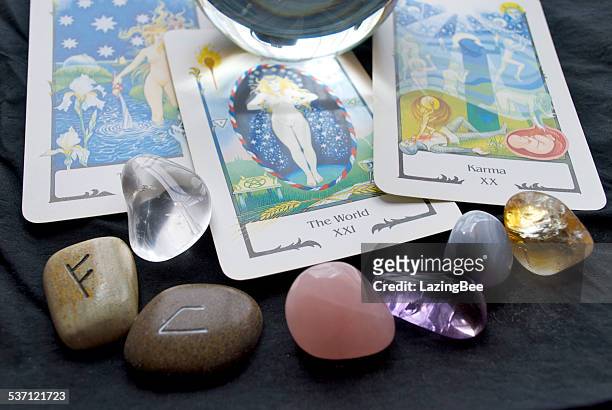 tarot reading with a crystal ball, runes and gemstones - tarot cards stock pictures, royalty-free photos & images