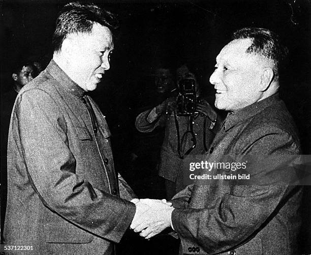 Pol Pot , Prime Minister of Cambodia and leader of the Khmer Rouge, shaking hands with Chinese Communist leader Deng Xiaoping at Phnom Penh, 1978.