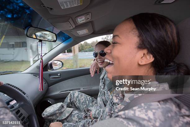 women in fatigues traveling by car - people in military uniform stock pictures, royalty-free photos & images