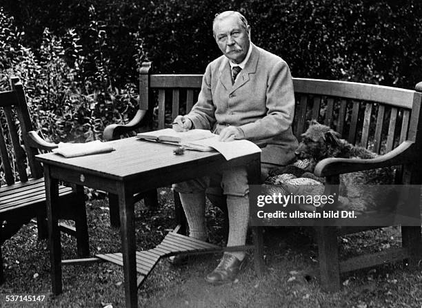 Sir Arthur Conan Doyle, , British writer and physician, in his garden