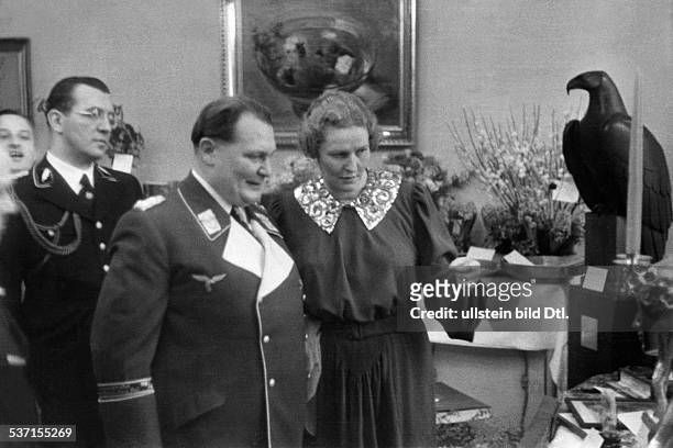 Hermann Göring,,Erich Gritzbach , Politician, NSDAP, Germany , - with his wife Emmy considering presents; hinter Gröing his personal adviser Dr....