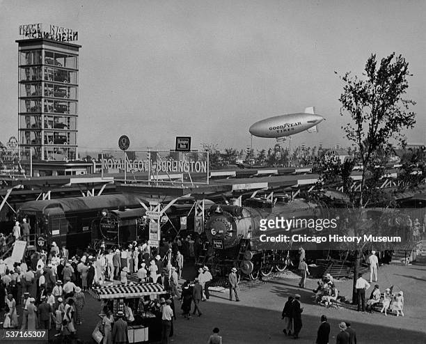 View of the Century of Progress world's fair, including the Burlington and Royal Scot trains, Goodyear Blimp, and Nash Autos, Chicago, Illinois, 1933.