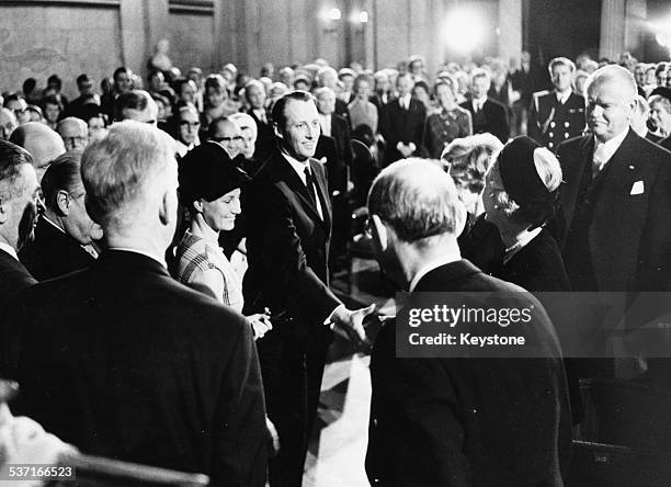 David A Morse, Director General of the International Labour Organization, is presented with the Nobel Peace Prize by Aase Lionaes in front of a crowd...