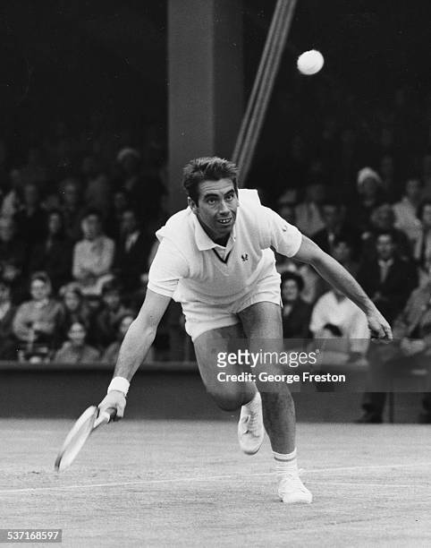 Spanish tennis player Manuel Santana in play against Graham Stilwell, on Court Number 1 at Wimbledon Tennis Tournament, London, June 27th 1968.