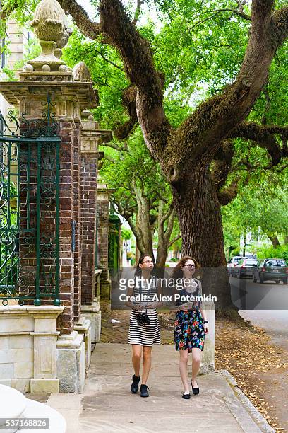 two teenager girls walks on the street - charleston south carolina stock pictures, royalty-free photos & images