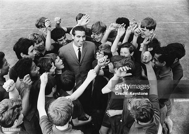 Spanish tennis player Manuel Santana surrounded by cheering Wimbledon ballboys, following his victory at the tennis tournament, London, July 2nd 1966.