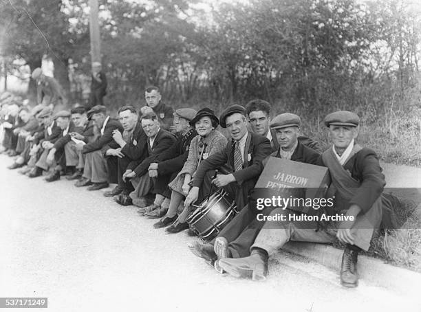 Labour Party politician Ellen Wilkinson, MP for Jarrow, sitting with a group of unemployed men taking part in an unemployment march, Jarrow, South...