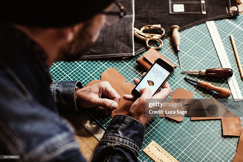 A craftsman checks his mobile website