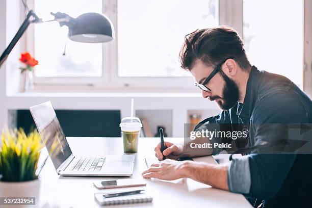 attractive man working at modern office space - smoothie sparse stock pictures, royalty-free photos & images