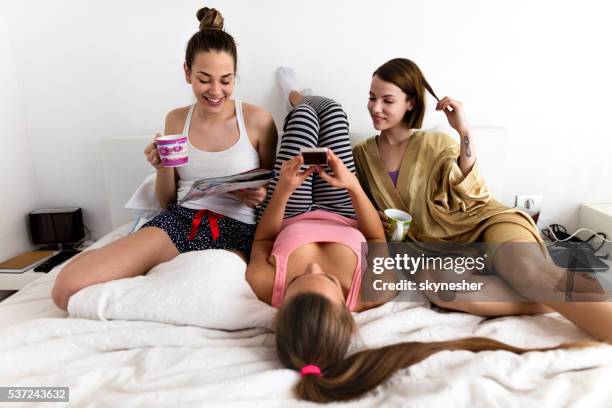 young smiling women relaxing in the bedroom. - girls' night in stock pictures, royalty-free photos & images