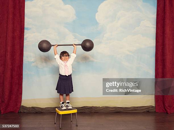 young business girl on stage lifting barbell - attitude stock pictures, royalty-free photos & images