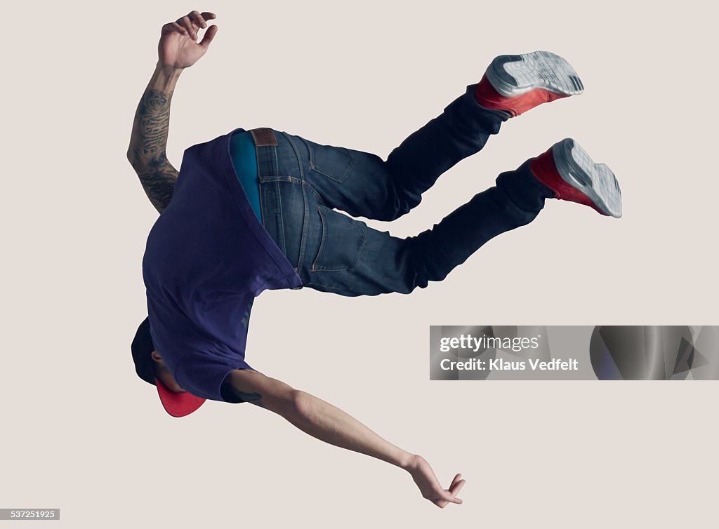 Young man hanging in the air, back to camera