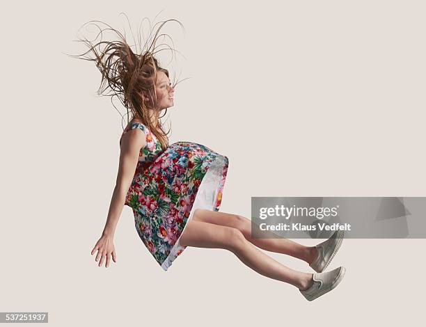 woman in dress in the air, falling down - floral pattern dress stockfoto's en -beelden