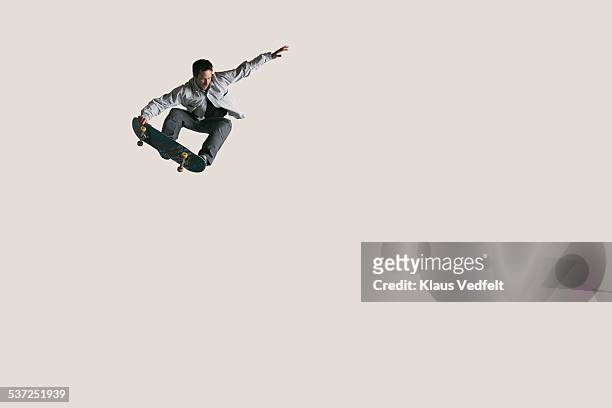 skateboarder doing big air & tail grabbing - people jumping fotografías e imágenes de stock