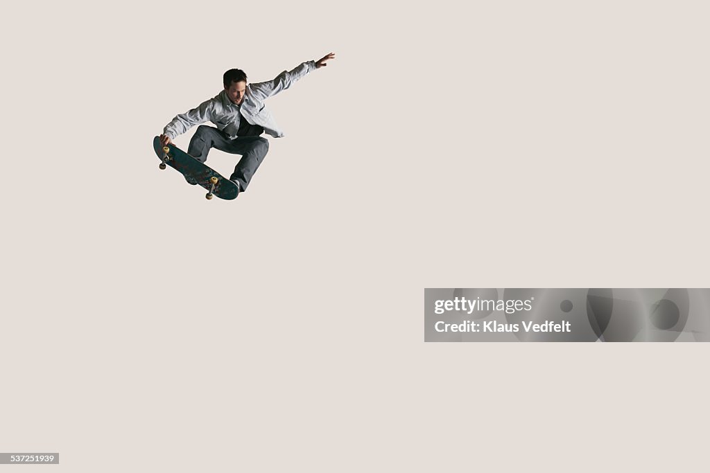 Skateboarder doing big air & tail grabbing