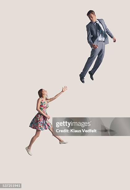 woman reaching out at businessman in the air - floating stock pictures, royalty-free photos & images