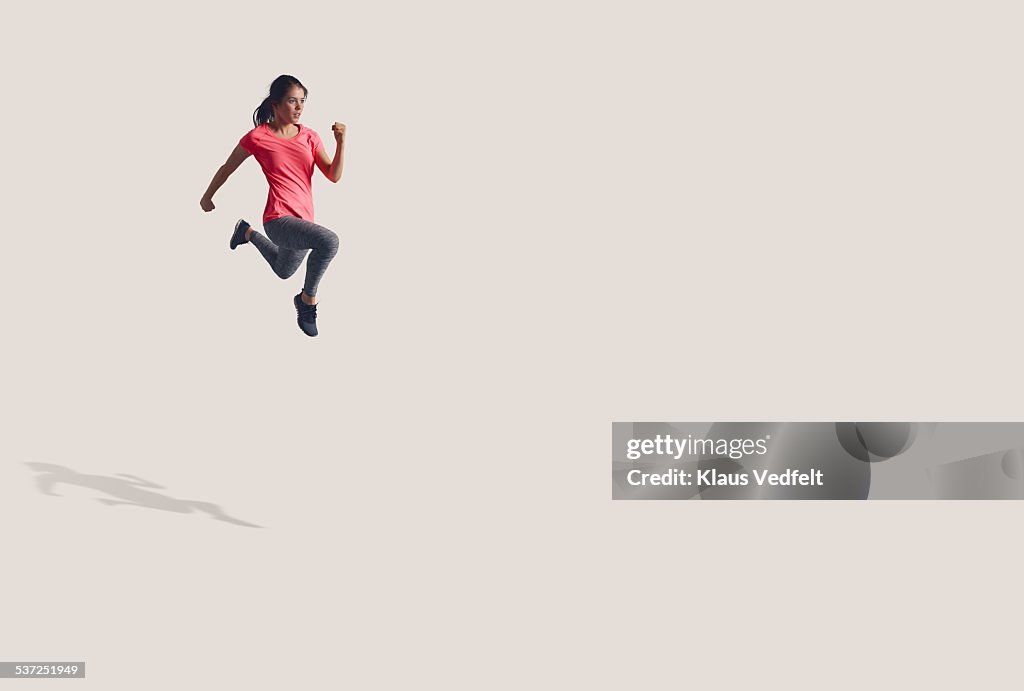 Woman running in the air in big space