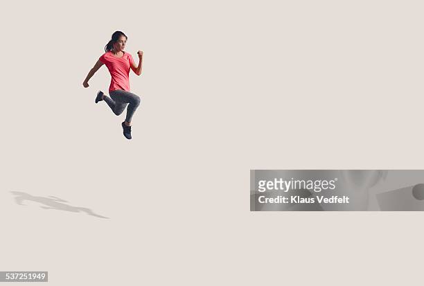 woman running in the air in big space - effortless imagens e fotografias de stock