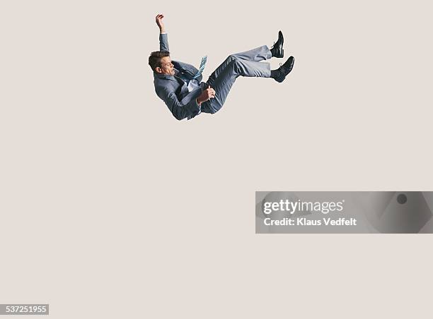 businessman in big space, falling down - unemployment stock-fotos und bilder