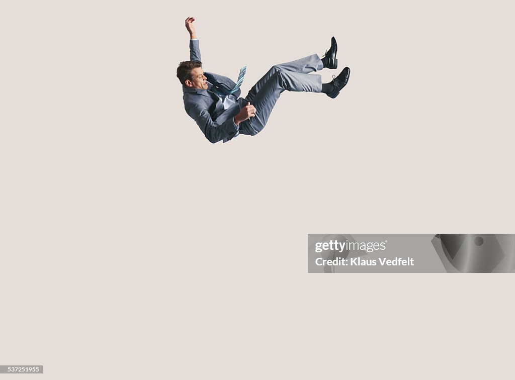 Businessman in big space, falling down