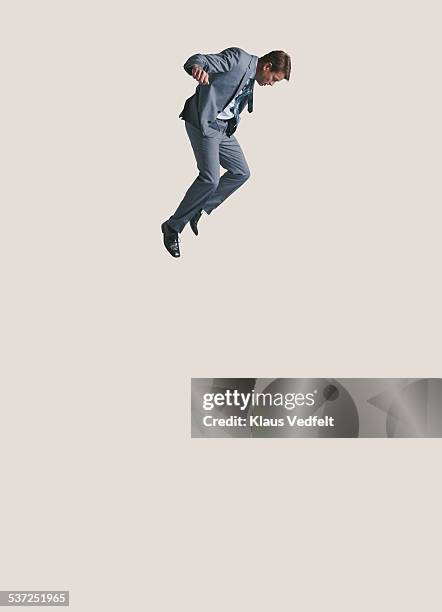 businessman looking down while in air and falling - person falling mid air stock pictures, royalty-free photos & images