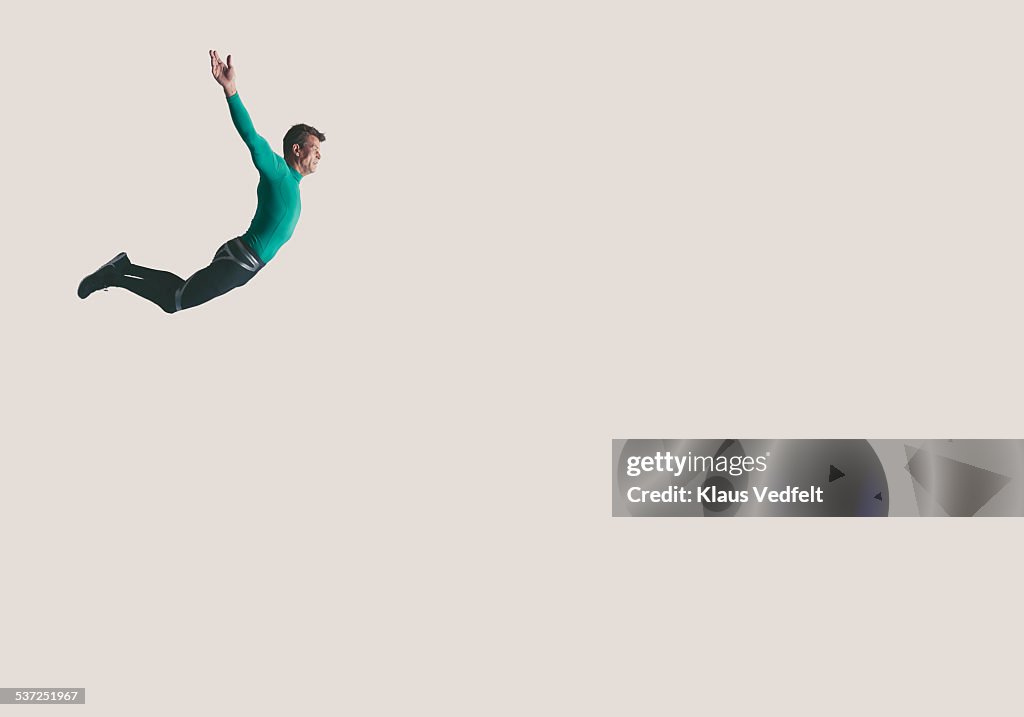 Mature athlete hanging in the air
