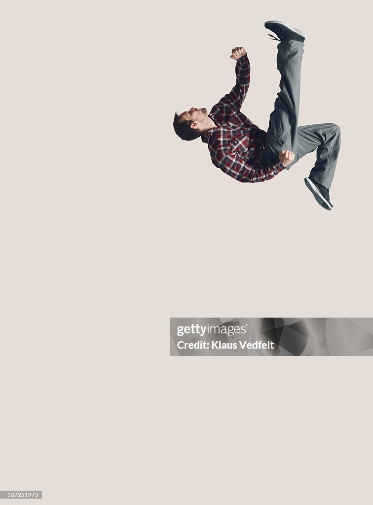 Man jumping in the air with one leg stretched