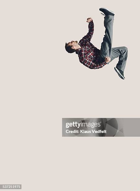 man jumping in the air with one leg stretched - high kick stock pictures, royalty-free photos & images