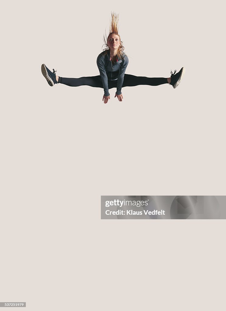 Woman doing split in the air