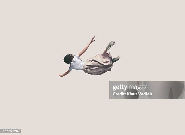 young woman with dress hanging in the air - jumping photos et images de collection