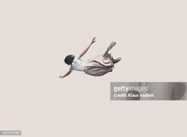 young woman with dress hanging in the air - volare foto e immagini stock