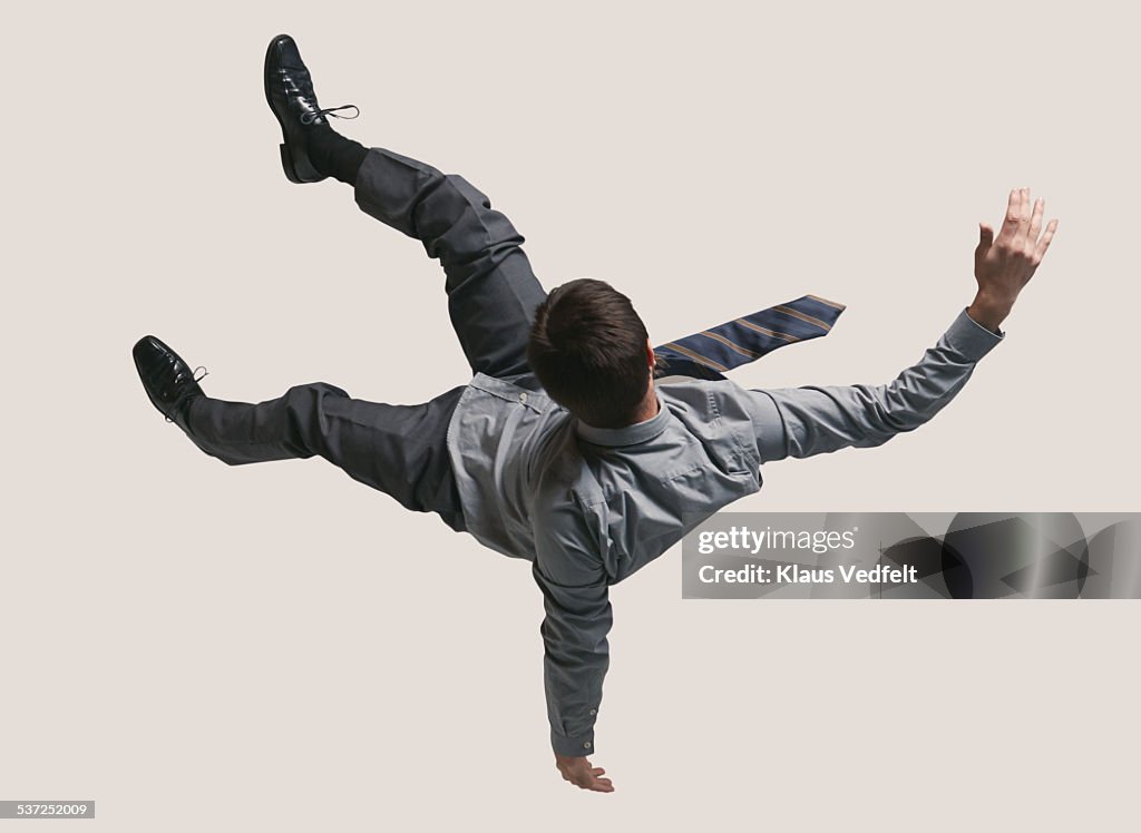 Young businessman in the air, falling down